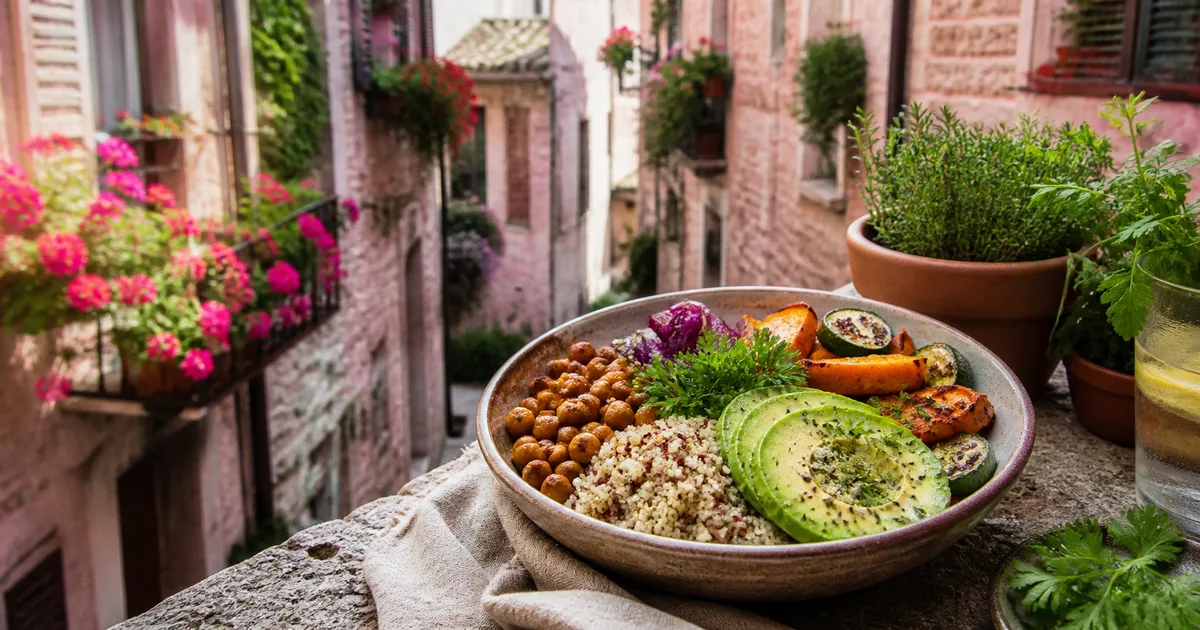 Consulenza vegan con piatto di legumi e verdure davanti al borgo di Spello